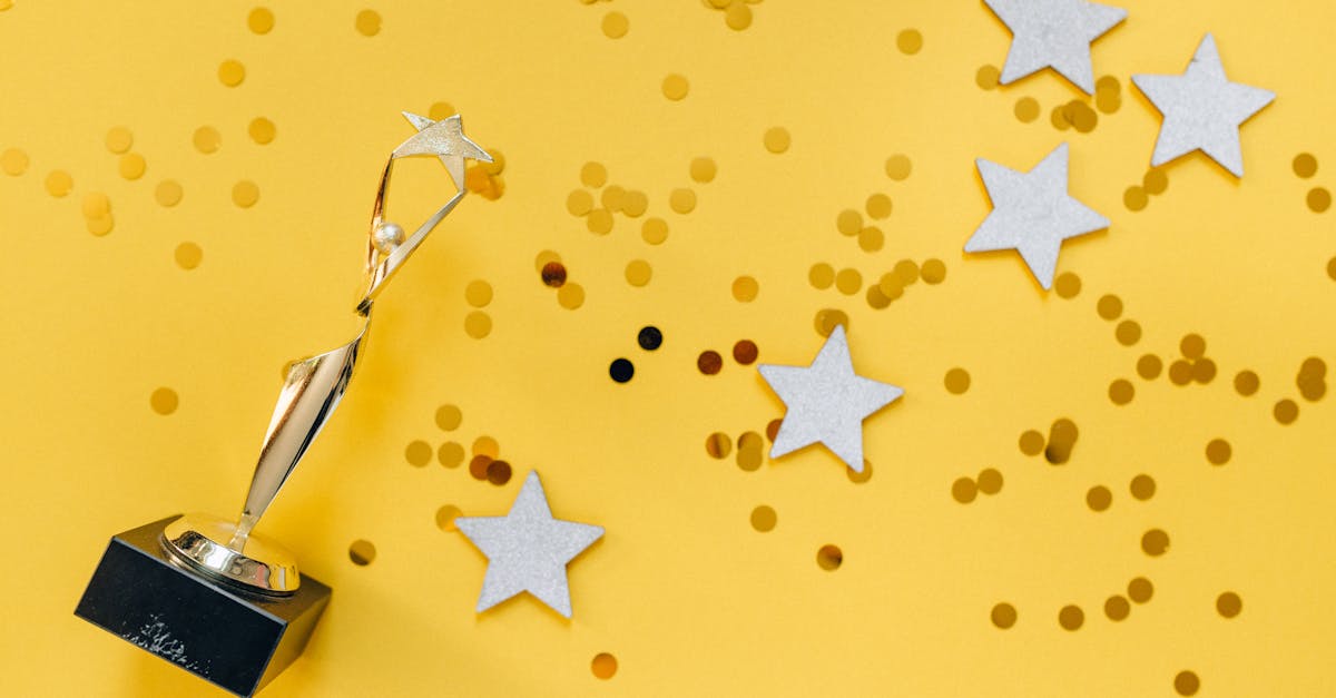 Shiny golden trophy and stars on a vibrant yellow background, symbolizing success and victory.