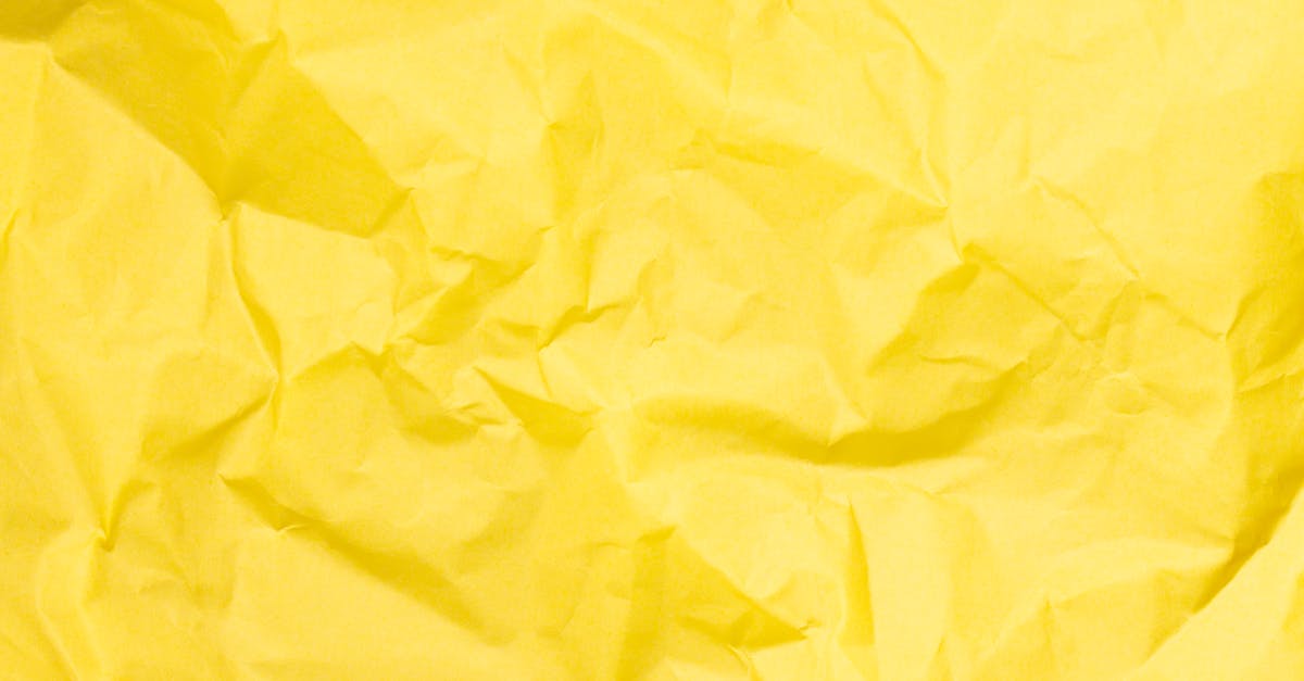 Bright yellow crumpled paper texture ideal for backgrounds in design projects.