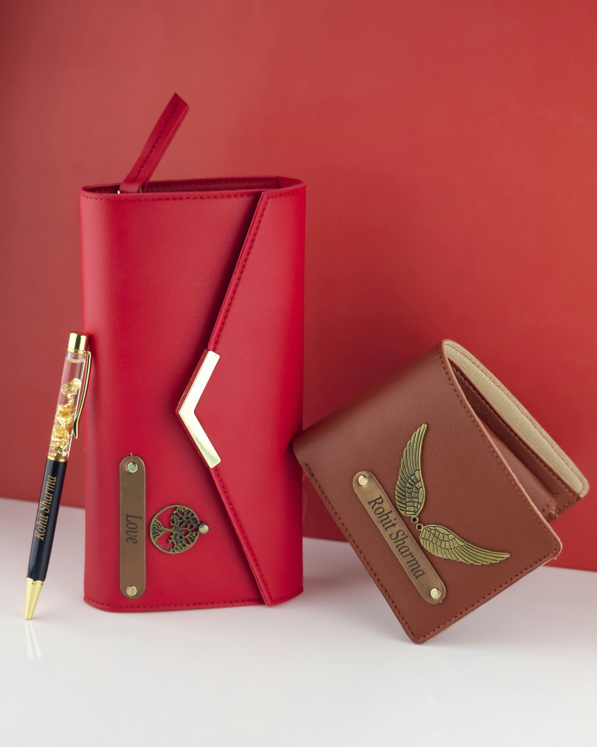 Elegant red leather portfolio and brown wallet with bespoke metal accents.